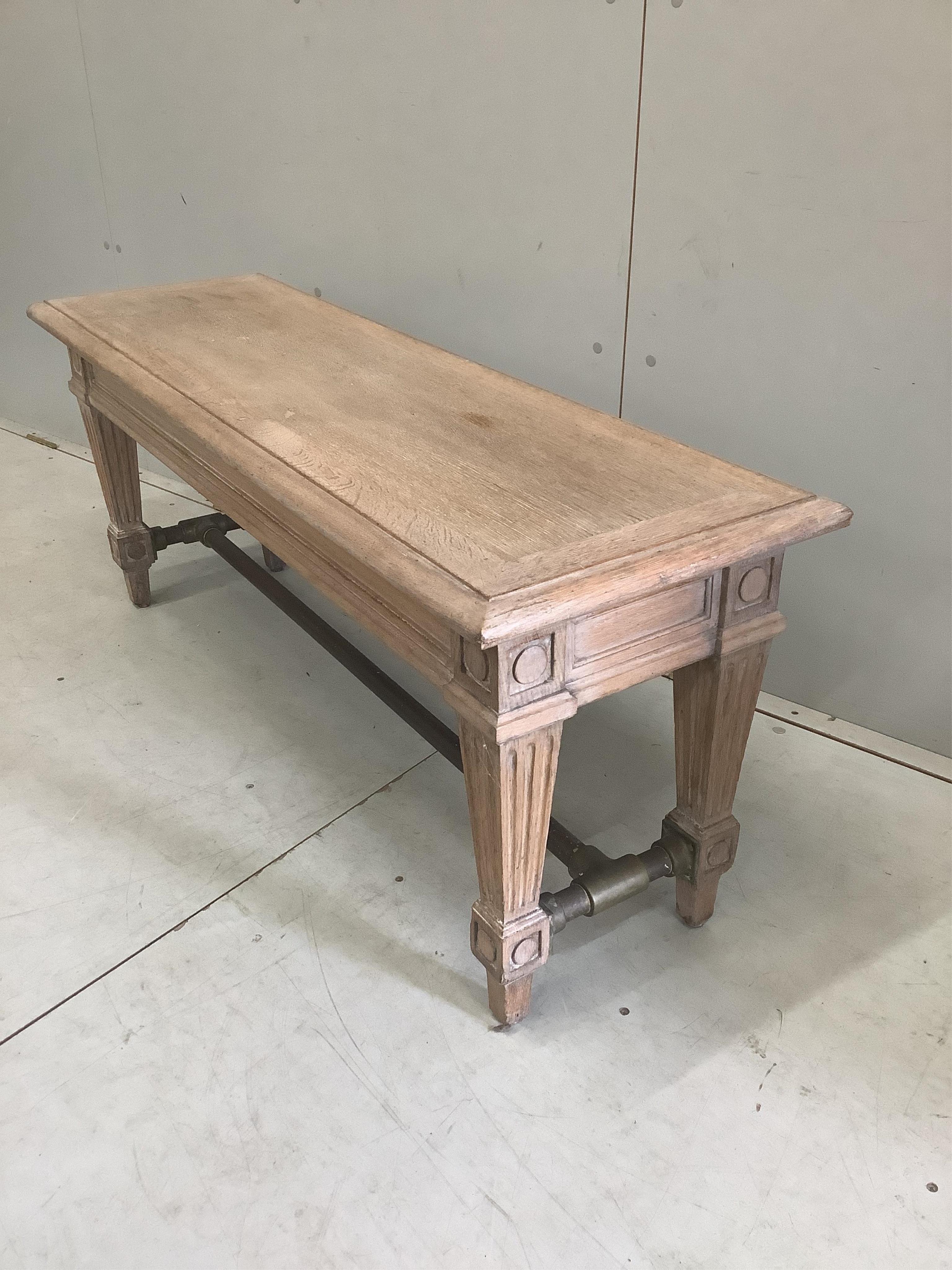 A modern limed oak window seat with industrial style brass stretcher, width 125cm, depth 40cm, height 50cm